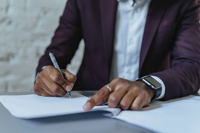 man signing will after a name change