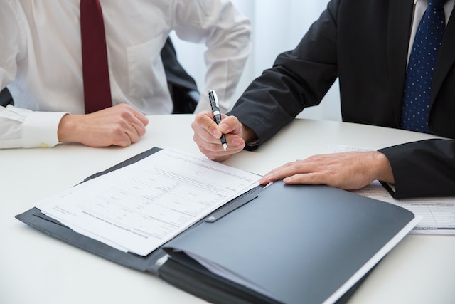 person writing on documents