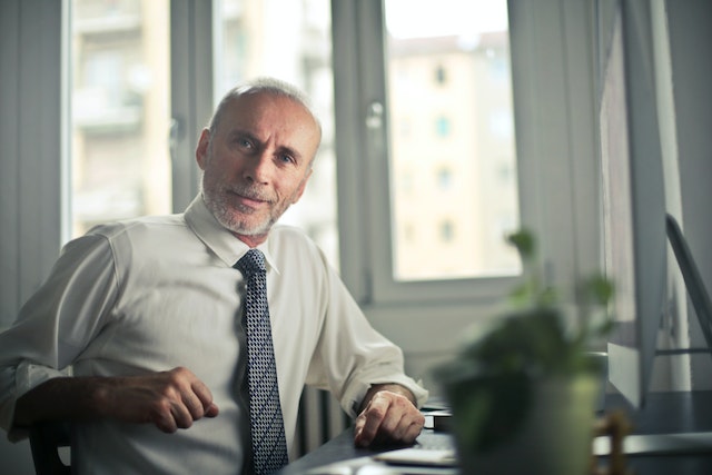 older man sitting at desk