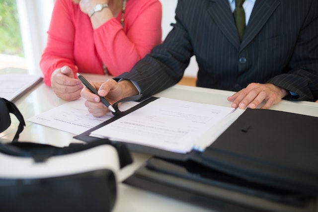 two people sitting in front of a document