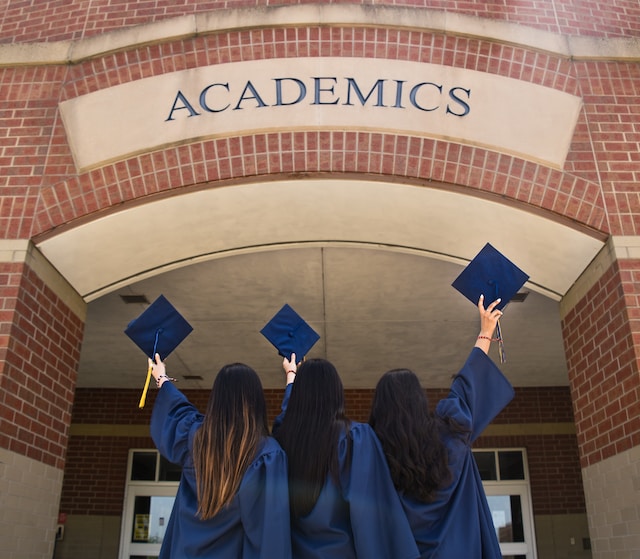 people holding graduation caps