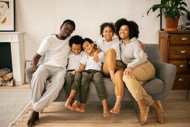 family sitting on a couch smiling