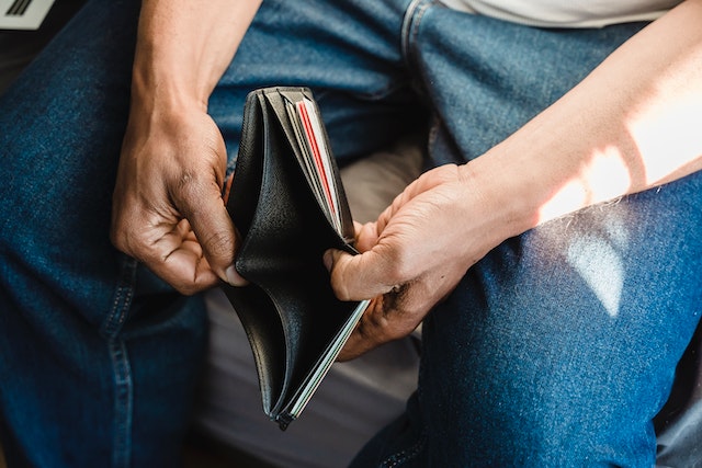 man holding empty wallet