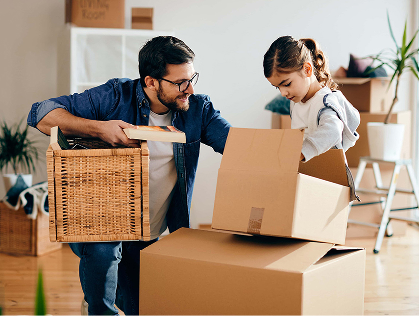 father and daughter unpacking boxes